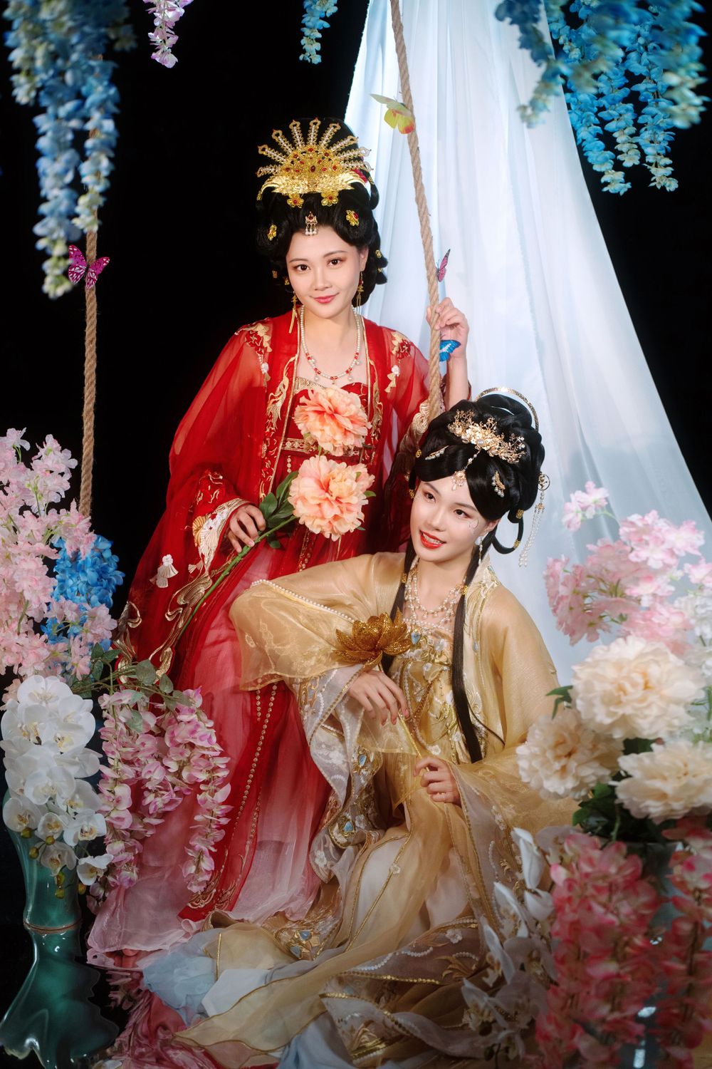 Elegant backlit studio portrait of mother and daughter in Tang Dynasty Hanfu on a swing among wisteria, by Imagine Image Studio.