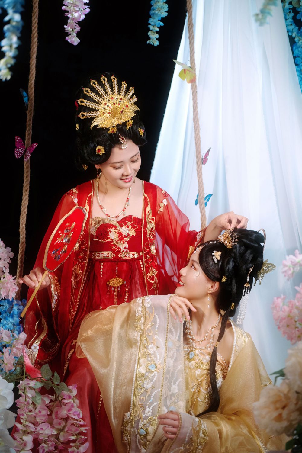 Elegant backlit studio portrait of mother and daughter in Tang Dynasty Hanfu on a swing among wisteria, by Imagine Image Studio.