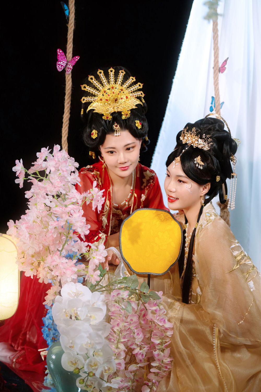 Elegant backlit studio portrait of mother and daughter in Tang Dynasty Hanfu on a swing among wisteria, by Imagine Image Studio.