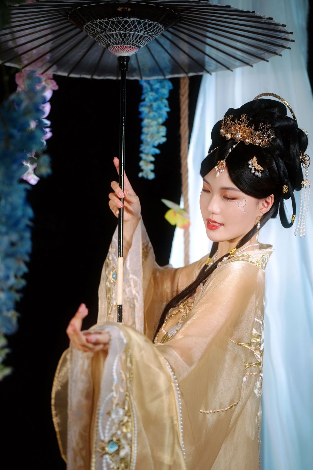 Elegant backlit studio portrait of mother and daughter in Tang Dynasty Hanfu on a swing among wisteria, by Imagine Image Studio.