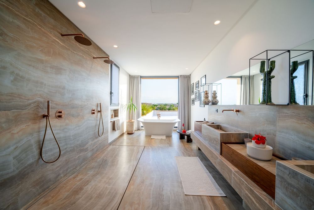 Modern bathroom interior with marble walls, wooden vanity, and sleek fixtures showcasing minimalist luxury design.