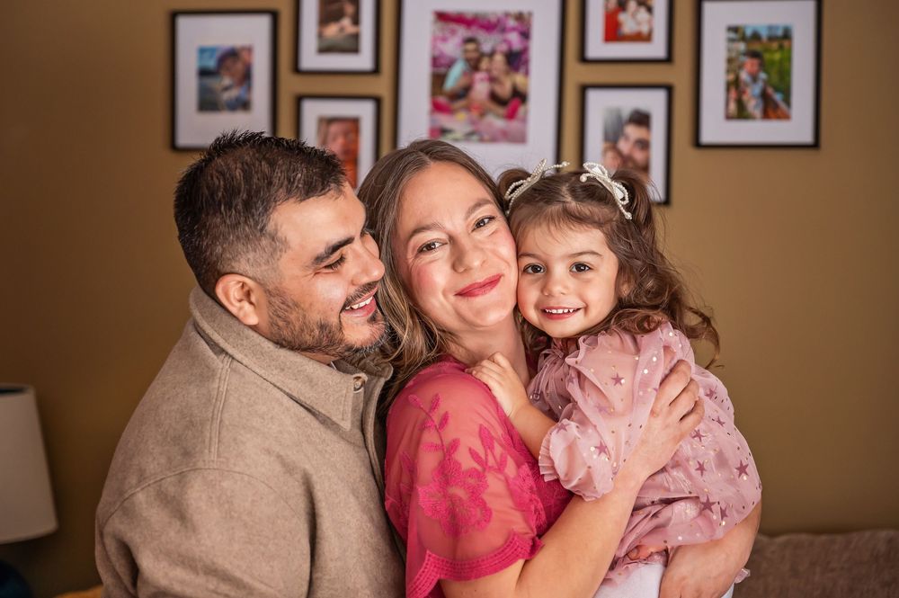 A loving family shares tender moments together in a series of warm-toned portrait photographs.