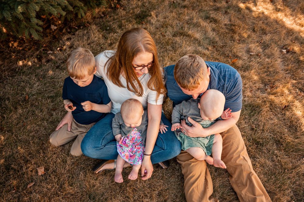 An outdoor family portrait taken from above during golden hour lighting.