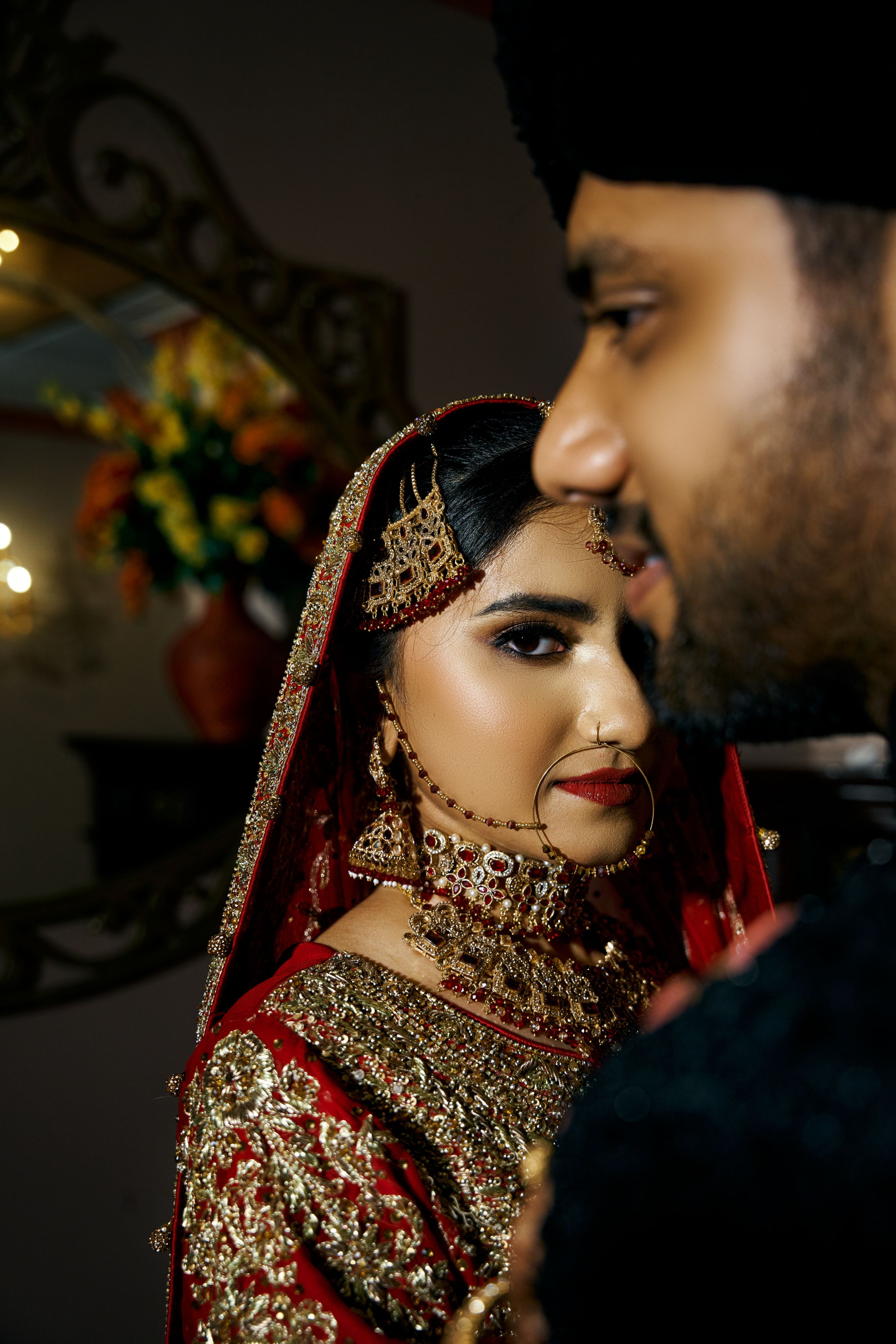 A romantic wedding scene with traditional Indian bridal jewelry and attire.