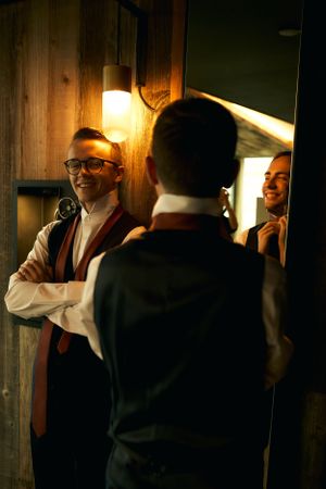 A dimly lit behind-the-scenes moment at a wedding venue with dramatic lighting.