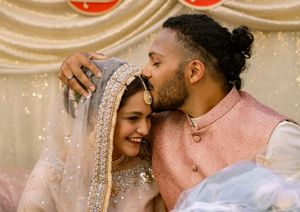 Romantic close-up moment between couple wearing sparkling formal attire.