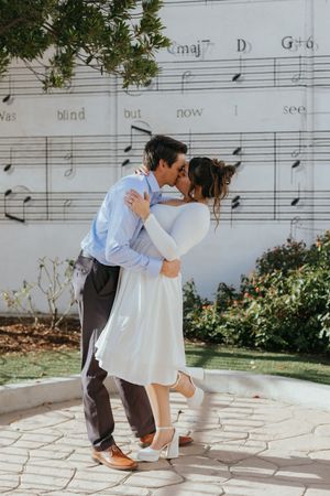engaged couple sharing a kiss outdoors during an engagement portrait session