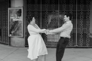 couple holding hands and smiling during a couples engagement session