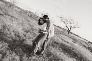 couple standing together on a hillside during an outdoor photo session
