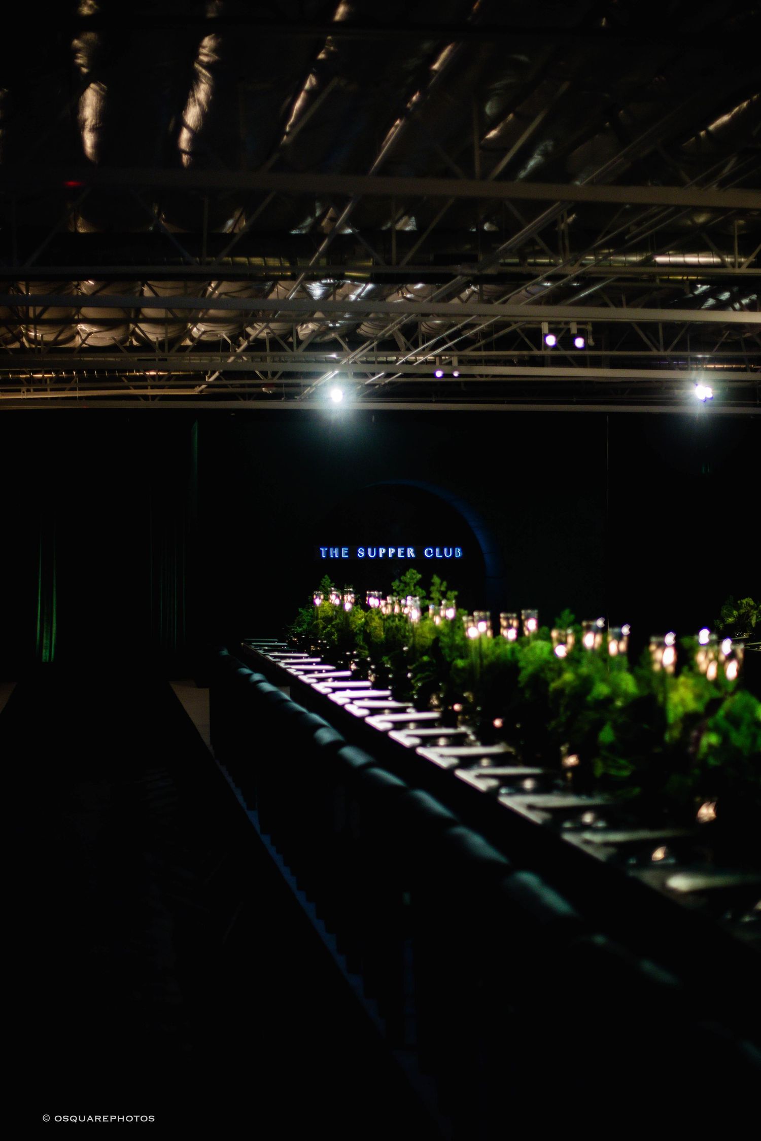 A series of dark concert stage lighting setups showing spotlights and illuminated patterns in a dimly lit venue.