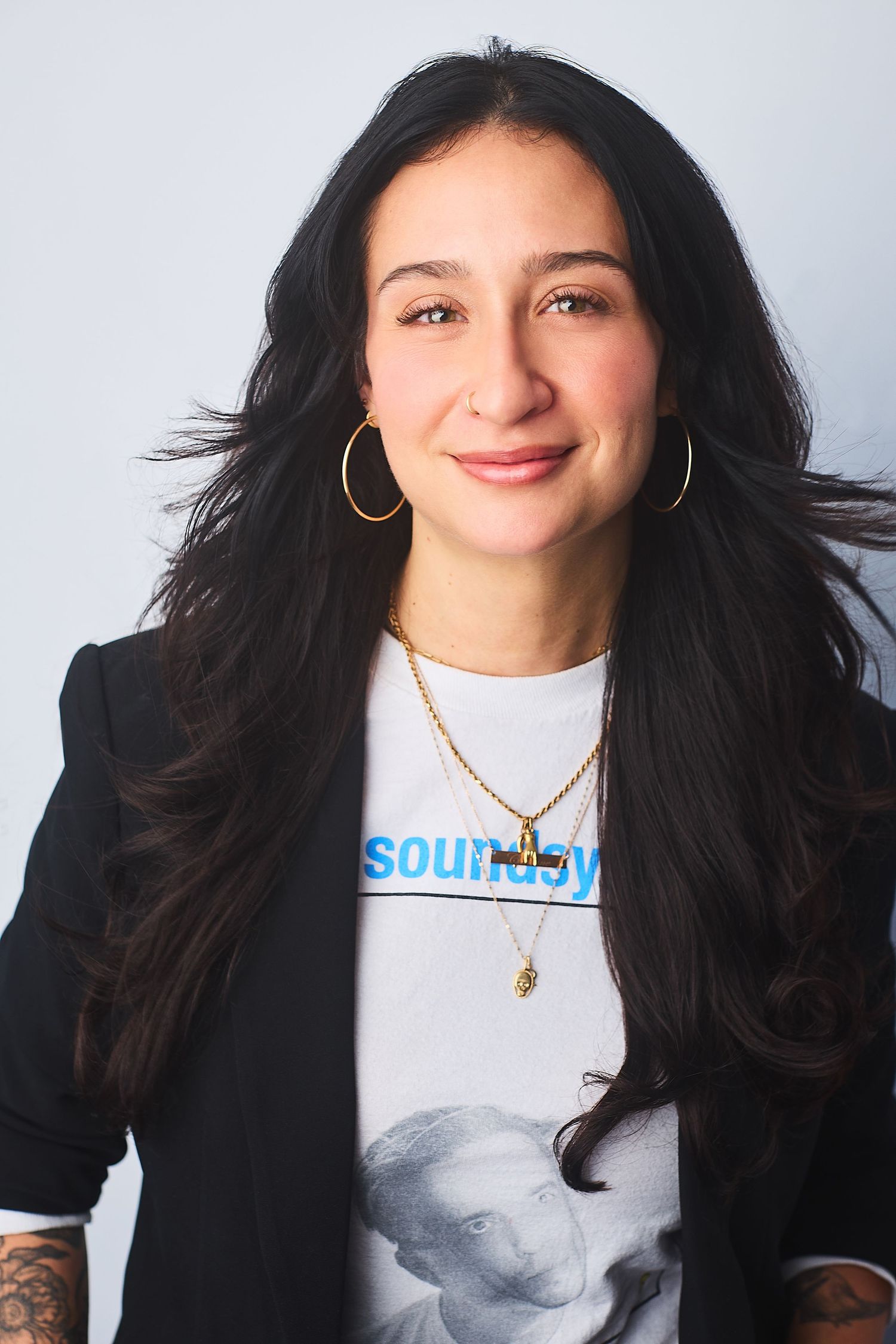 Corporate NYC headshot of a woman in a t-shirt and blazer.