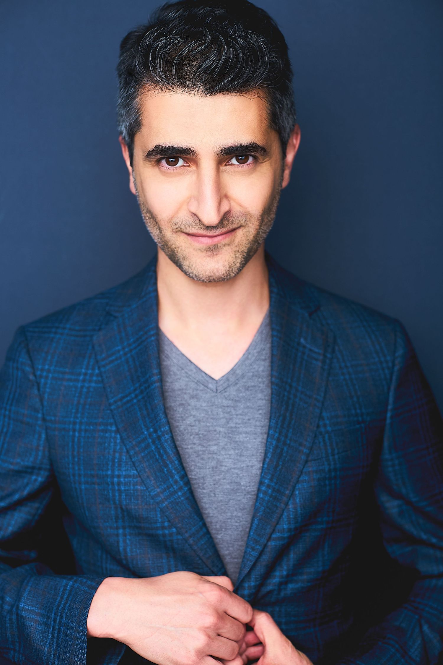 Corporate NYC headshot of a man in a blue suit.