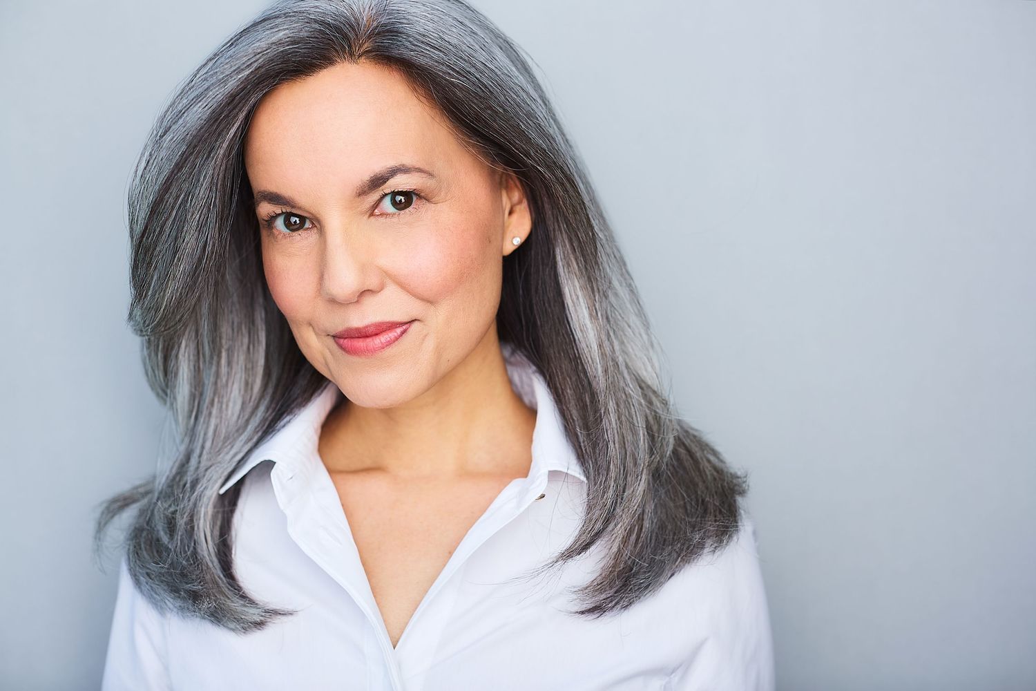 Corporate NYC headshot of a woman in a white shirt.