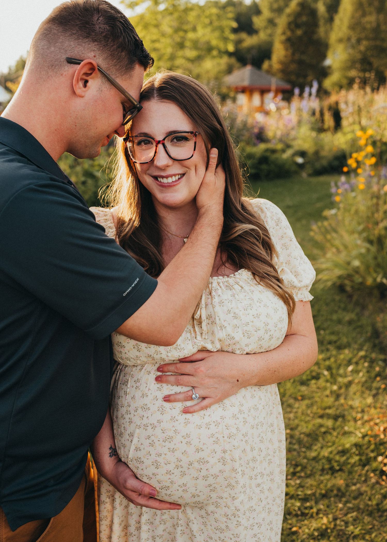 Expecting couple embracing outdoors during a maternity session