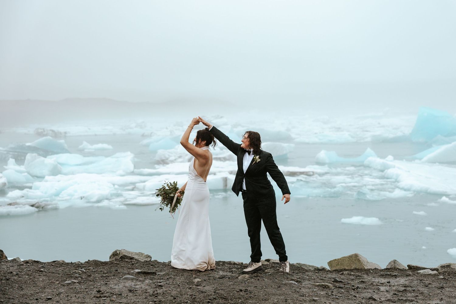 bride twirling her wife at Jokulsarlon glacier lagoon in iceland during elopement