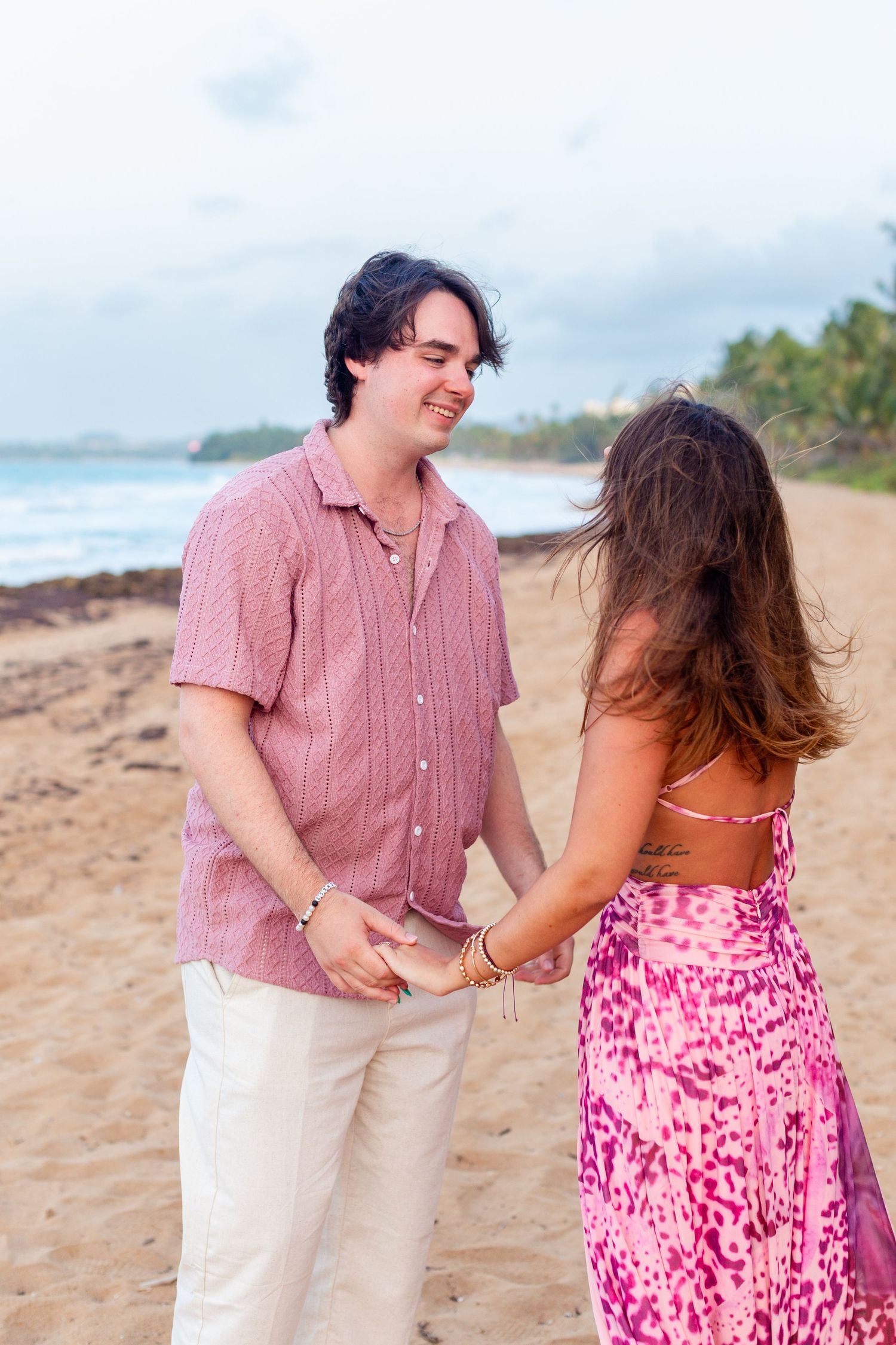 Couples portrait on the beach. Facing each other, holding hands. Río Grande, Puerto Rico.
