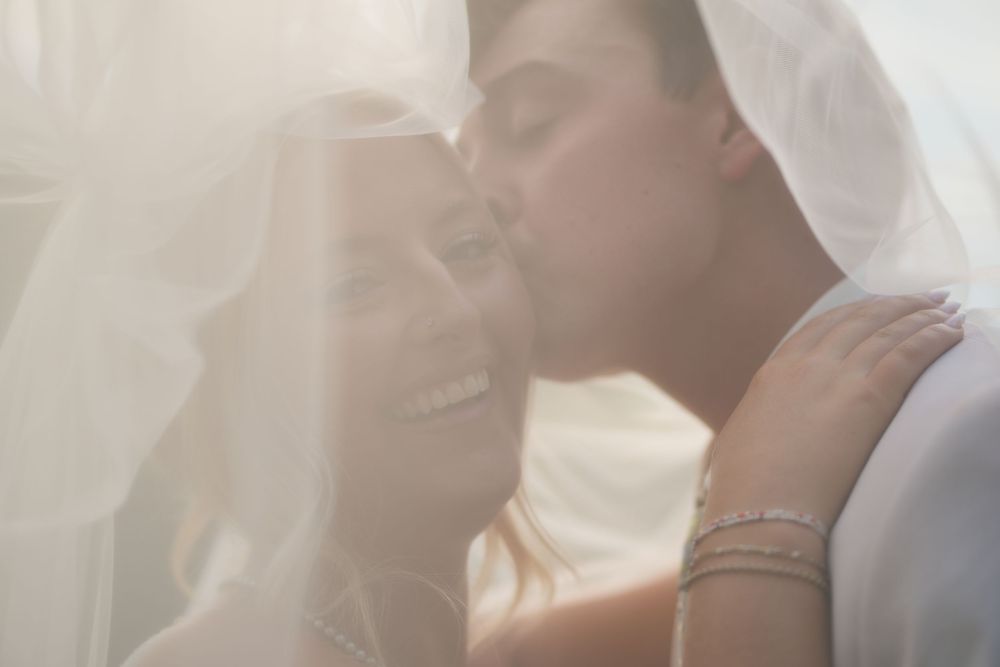bride and groom warmly lit under her veil