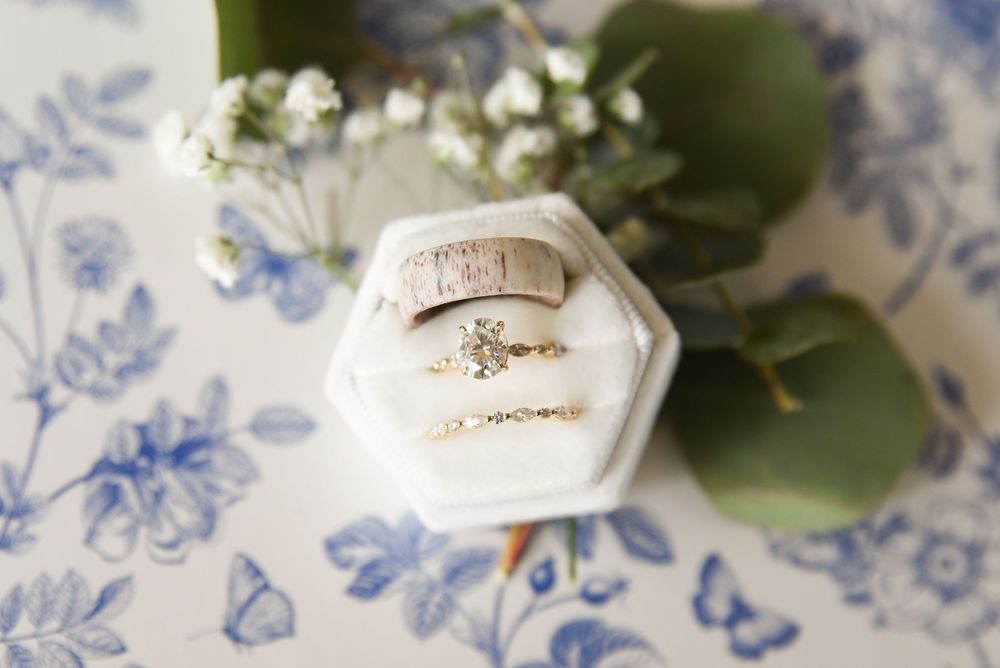 detail image of bridal ring set and groom's ring in a flat lay