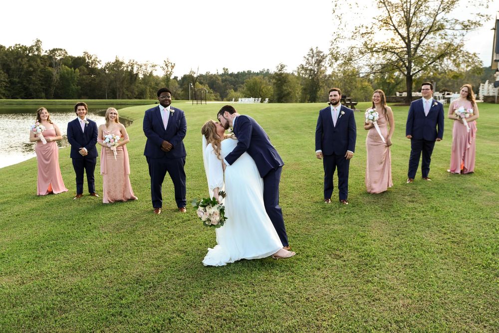 couple kissing wedding party