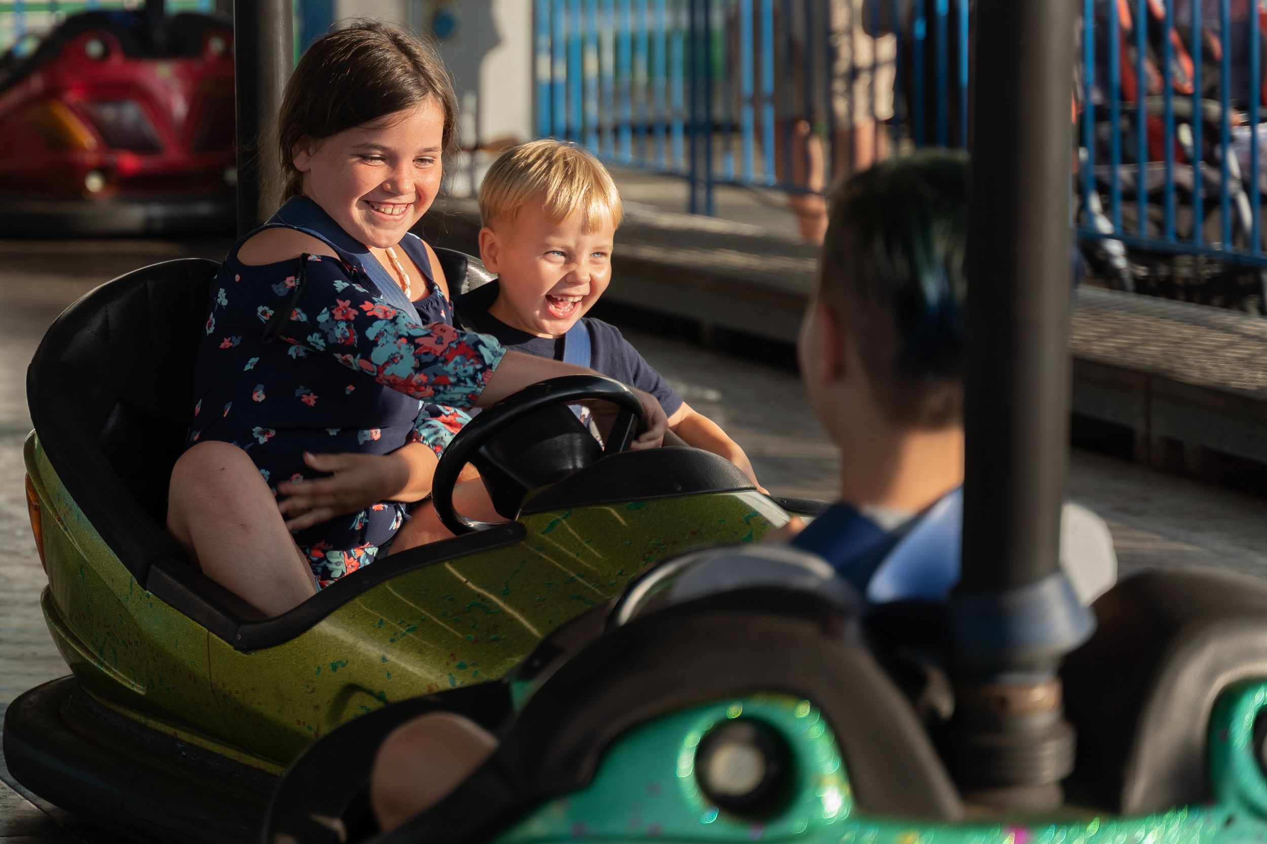 Child enjoying amusement park ride.