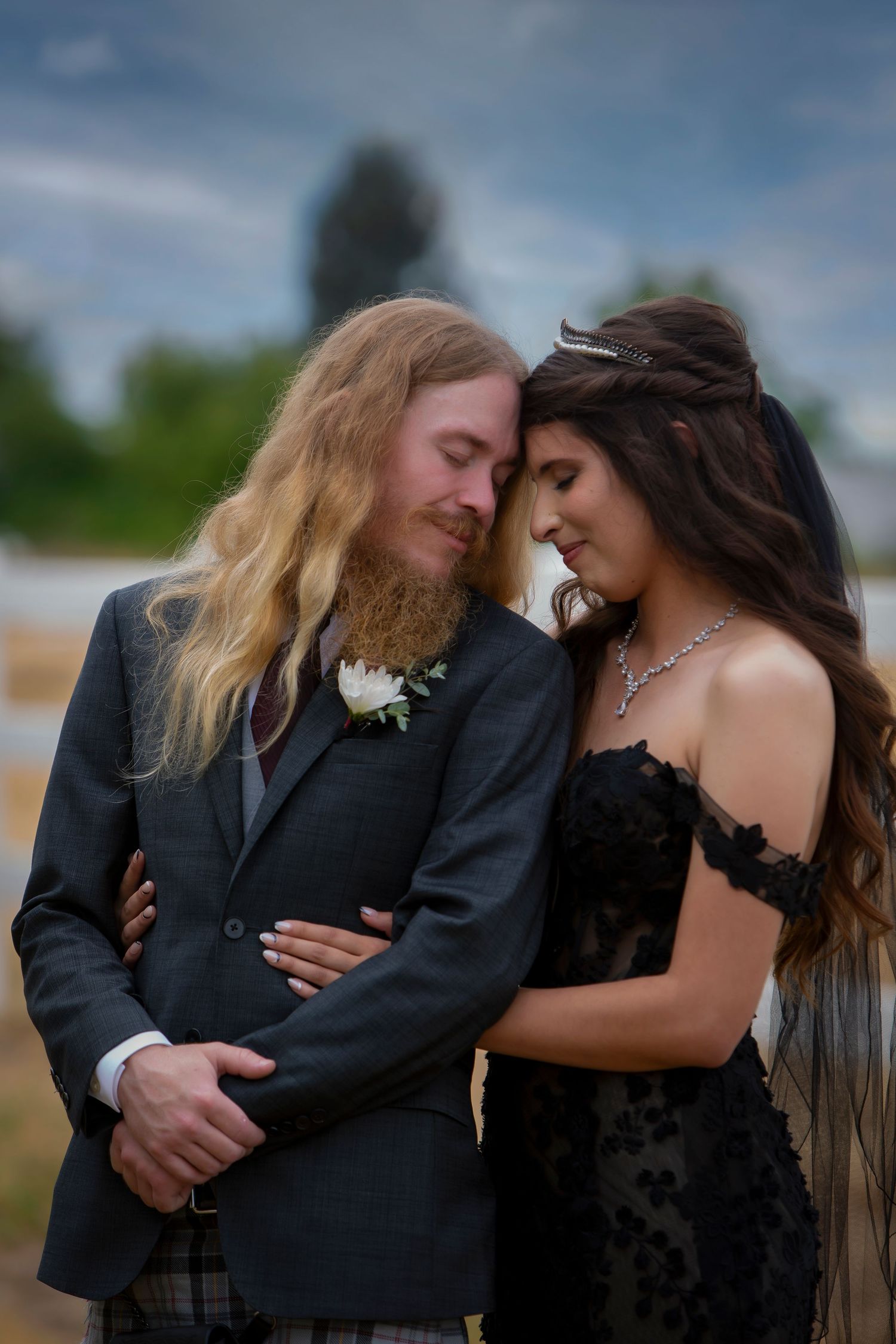 Castle Gardens Kuna Idaho ©Milestones Studios LLC bride and groom embrace closeup with dramatic sky