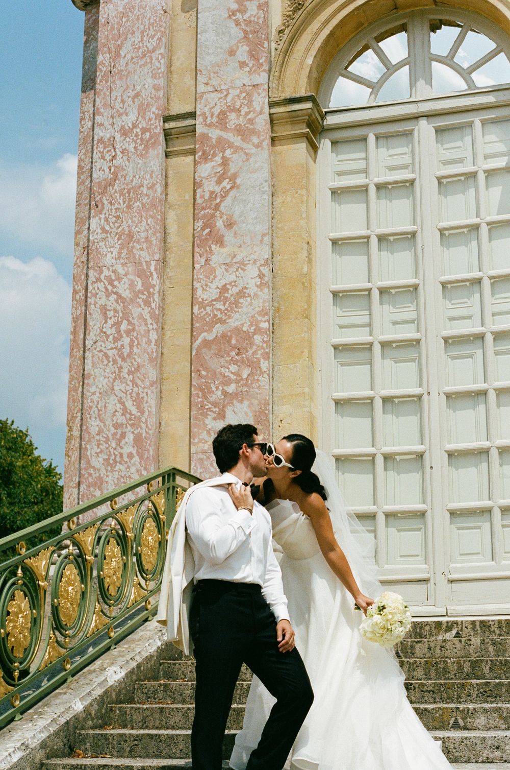 Bride and groom kissing at Chateau de Versailles, Le grand trianon wedding, versailles wedding photos, film vintage wedding photography