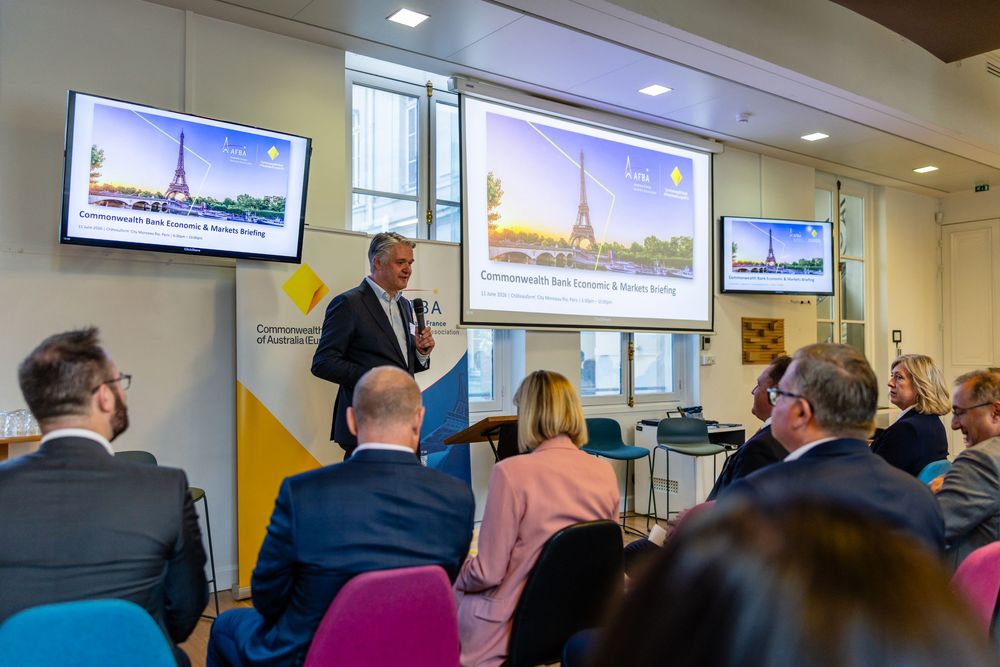 Audience at AFBA Commonwealth Bank of Australia event with Eiffel Tower screens, Paris - parisianphotographers.com