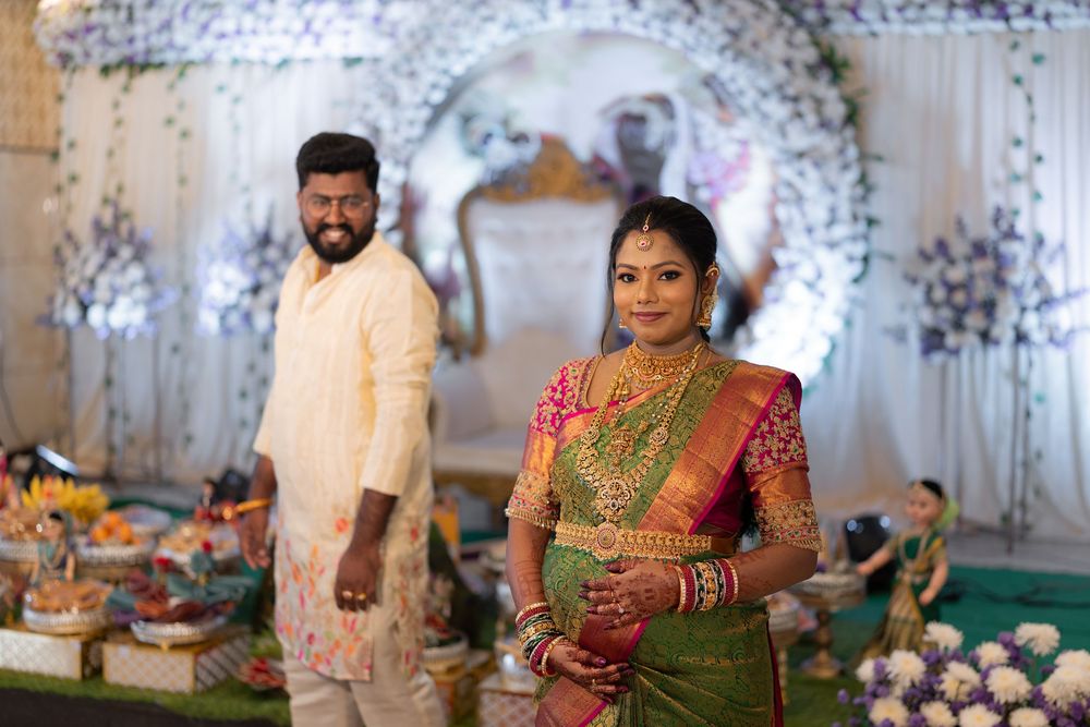 South Indian bride in green Kanjivaram saree with groom in white kurta at traditional wedding ceremony.