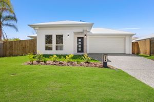Neat white single-storey home with double garage, gravel driveway, and lush green lawn.