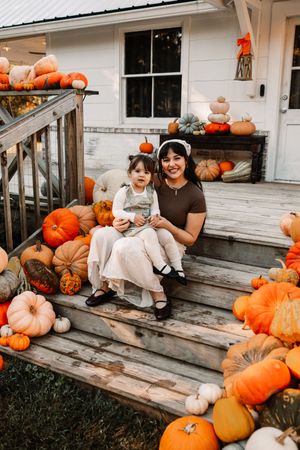 Mother and daughter sit on wooden steps at The Holmstead Studio in Karns, TN with Nina Thomas Photography.
