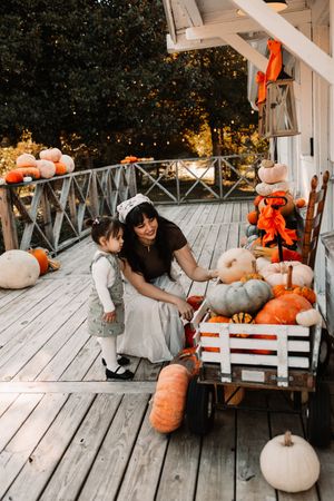 Woman and toddler girl explore colorful pumpkins at The Holmstead Studio in Karns, TN with Nina Thomas Photography.