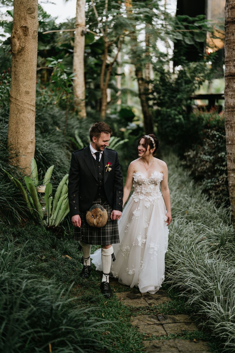 Wedding couple surrounded by tropical greenery at Capella Ubud Bali
