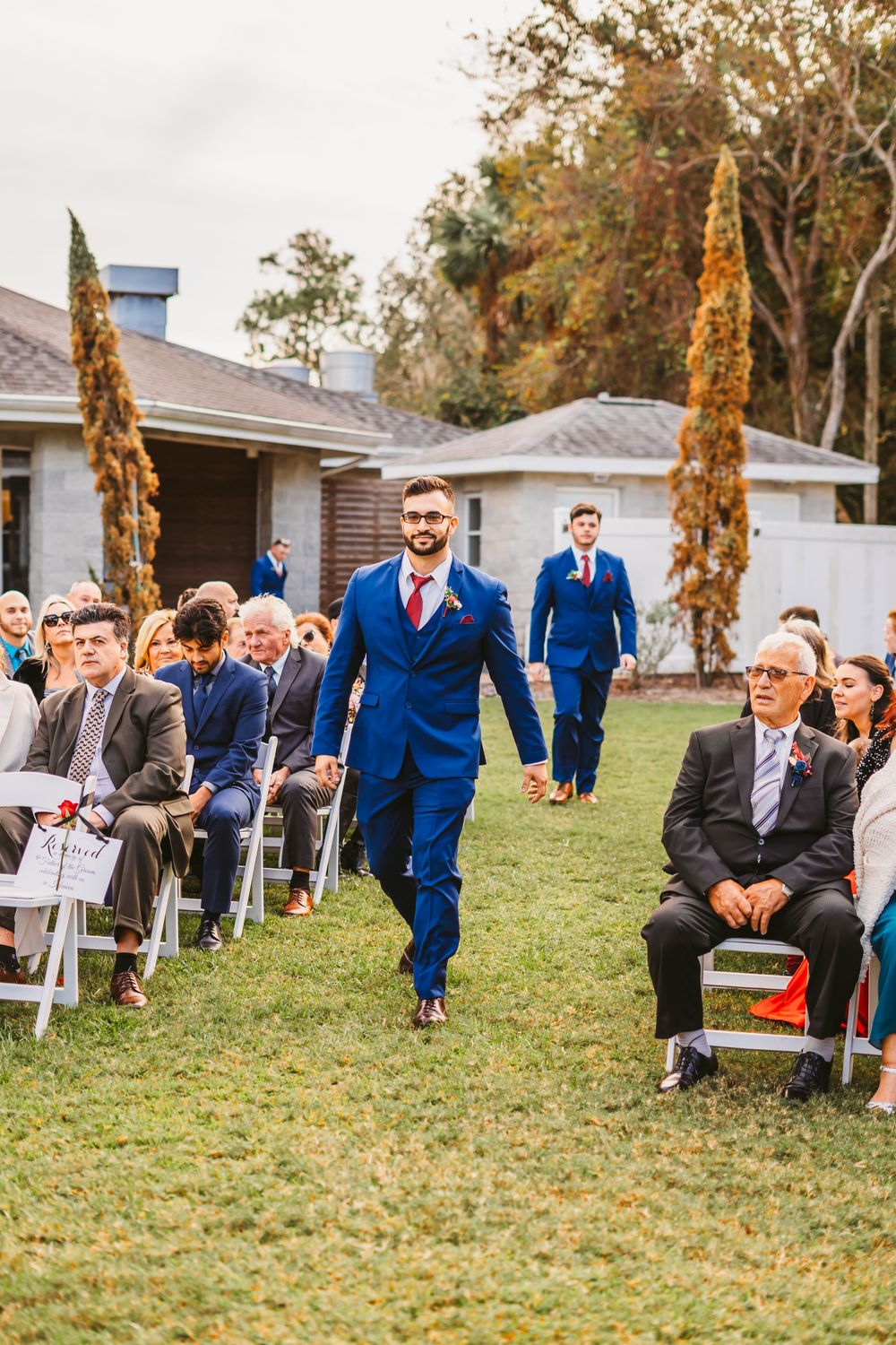 Channel Side Club in Palm Coast Florida. Wedding photography of outdoor ceremony. Navy blue suits and red bridesmaids gowns. Princess gown.