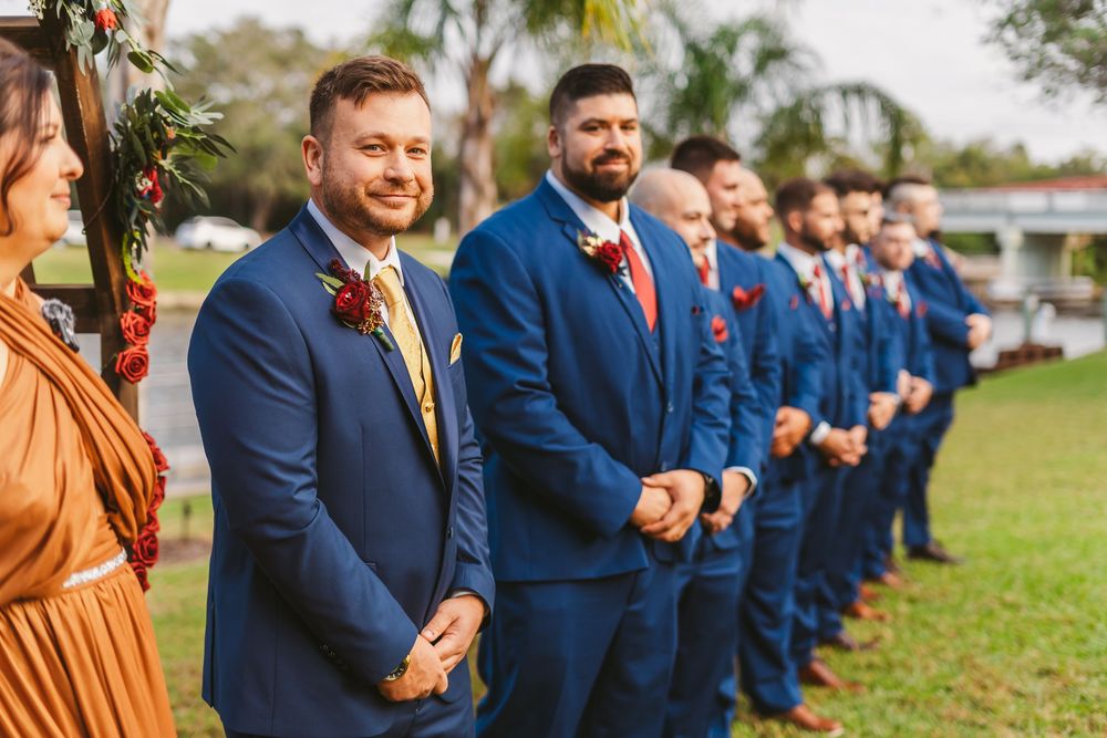 Channel Side Club in Palm Coast Florida. Wedding photography of outdoor ceremony. Navy blue suits and red bridesmaids gowns. Princess gown.