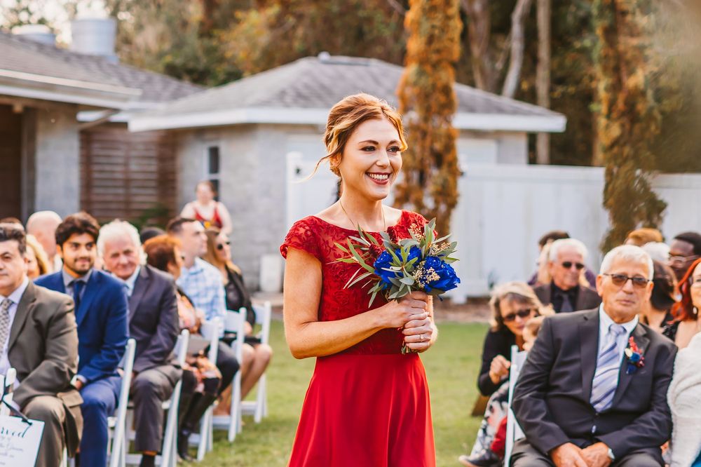 Channel Side Club in Palm Coast Florida. Wedding photography of outdoor ceremony. Navy blue suits and red bridesmaids gowns. Princess gown.