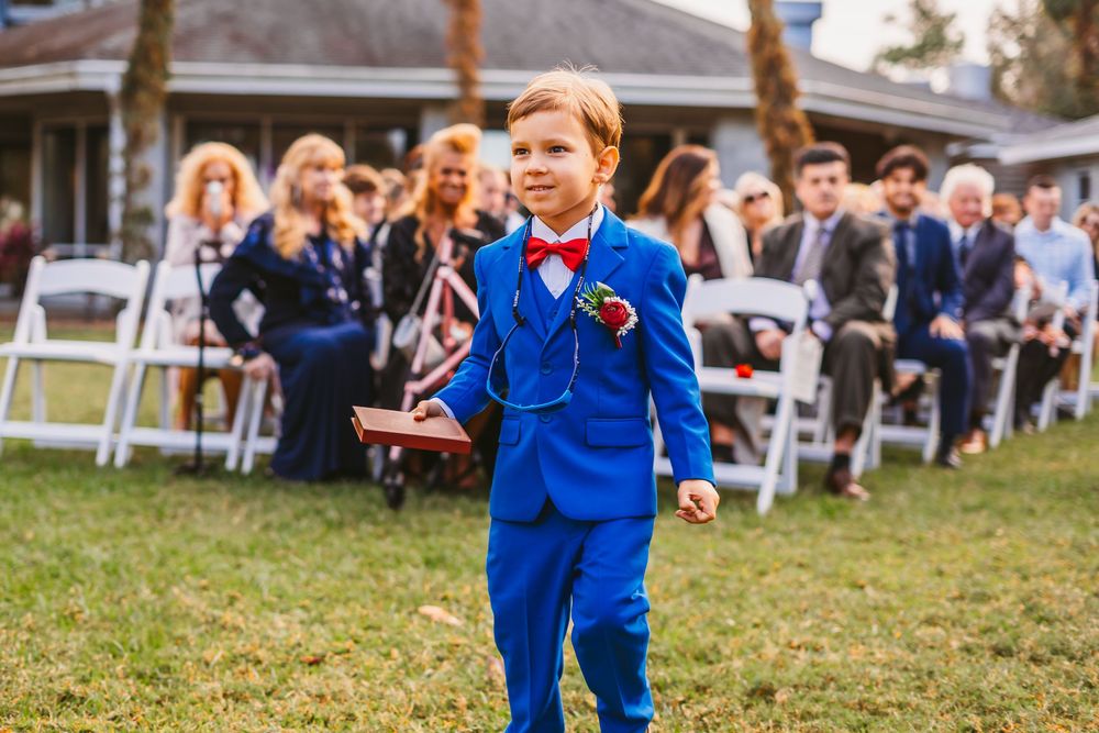 Channel Side Club in Palm Coast Florida. Wedding photography of outdoor ceremony. Ring bearer walks the aisle.