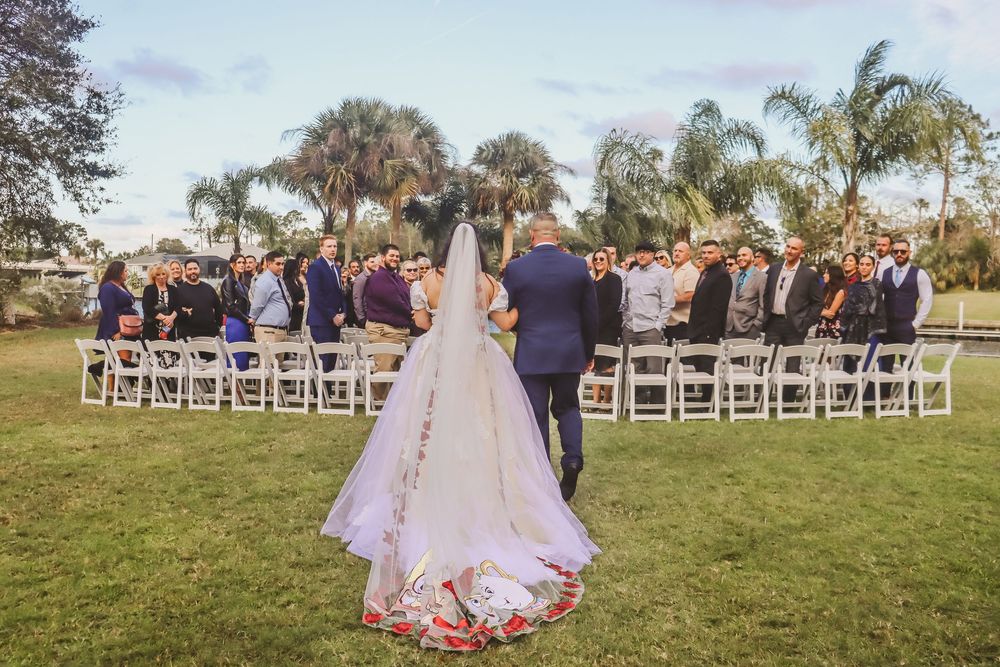 Channel Side Club in Palm Coast Florida. Wedding photography of walk down the aisle. Beauty and the beast embroidered veil.