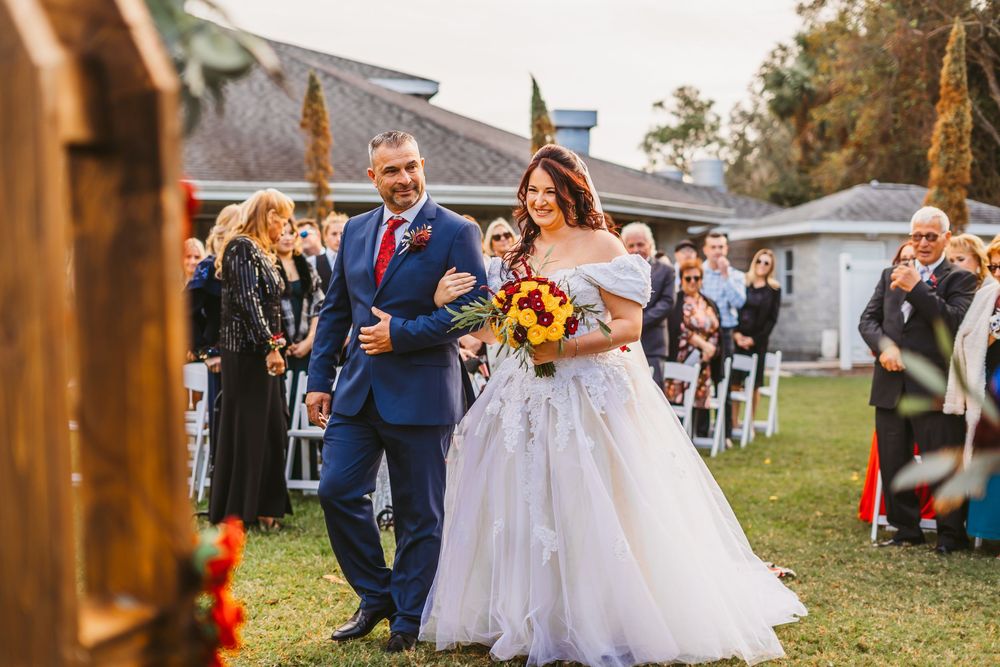 Channel Side Club in Palm Coast Florida. Wedding photography of outdoor ceremony. Bride wears princess gown while walking down aisle.