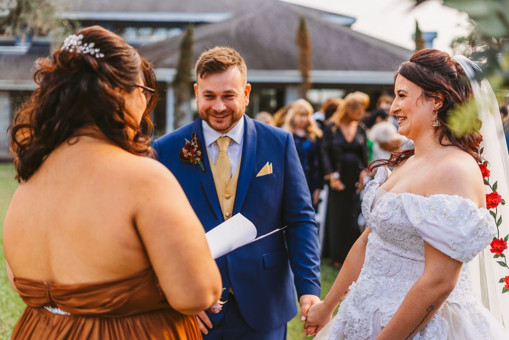 Channel Side Club in Palm Coast Florida. Wedding photography of outdoor ceremony. Bride wears princess gown while walking down aisle.
