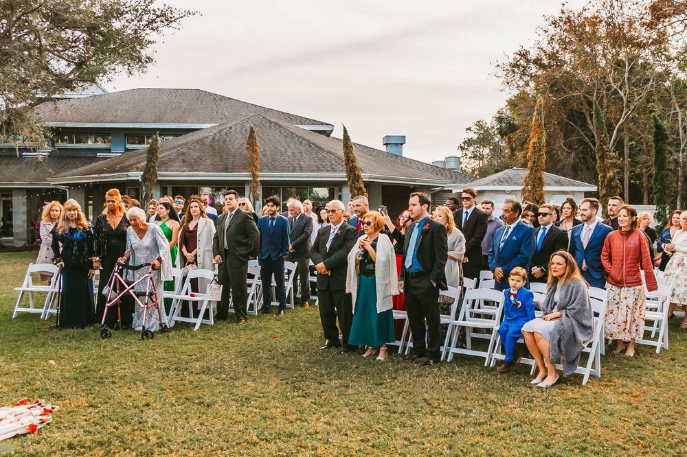 Channel Side Club in Palm Coast Florida. Wedding photography of outdoor ceremony. Bride wears princess gown while walking down aisle.