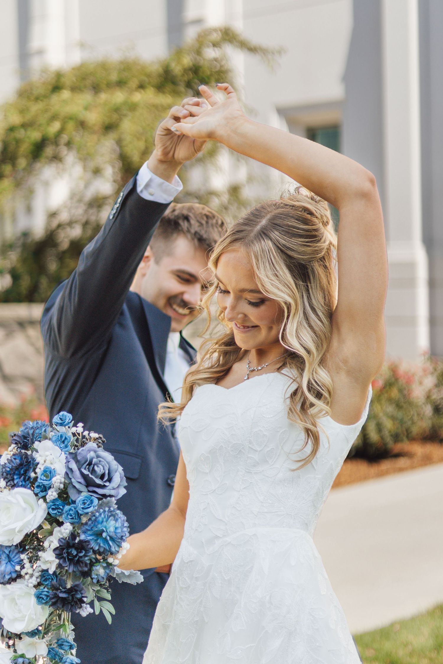 First look for bride and groom spinning in front of the Brigham City Utah LDS temple