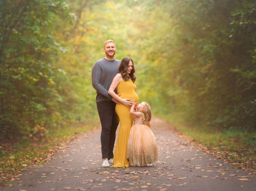 Family portrait in a scenic New Jersey park surrounded by trees and natural greenery.