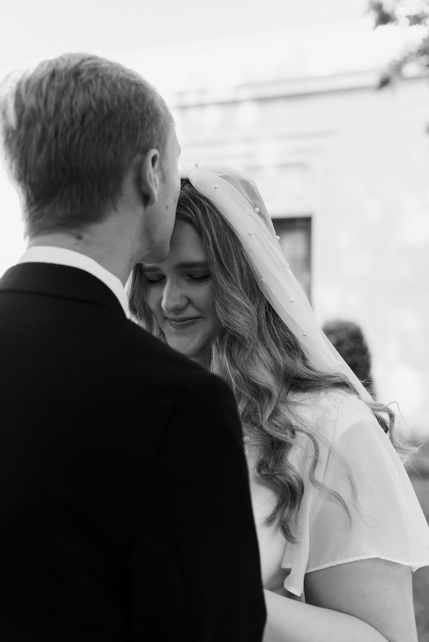 Rand Bryan House Wedding Couple, Ellie and Spencer. Groom kissing Bride's forehead. Photos by Beth MK Photo