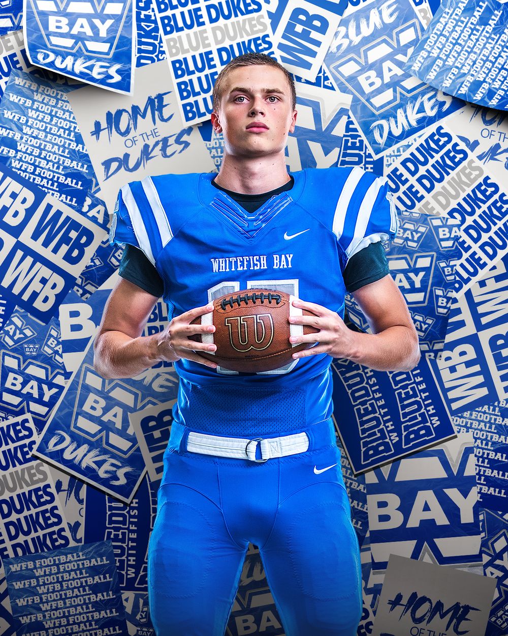 Whitefish Bay Blue Dukes football player in blue uniform holding a Wilson football against a team logo backdrop.