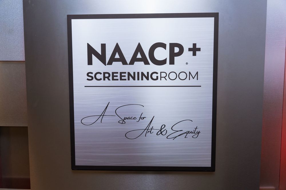 NAACP+ Screening Room sign reading 'A Space for Art & Equity' displayed at an event venue.