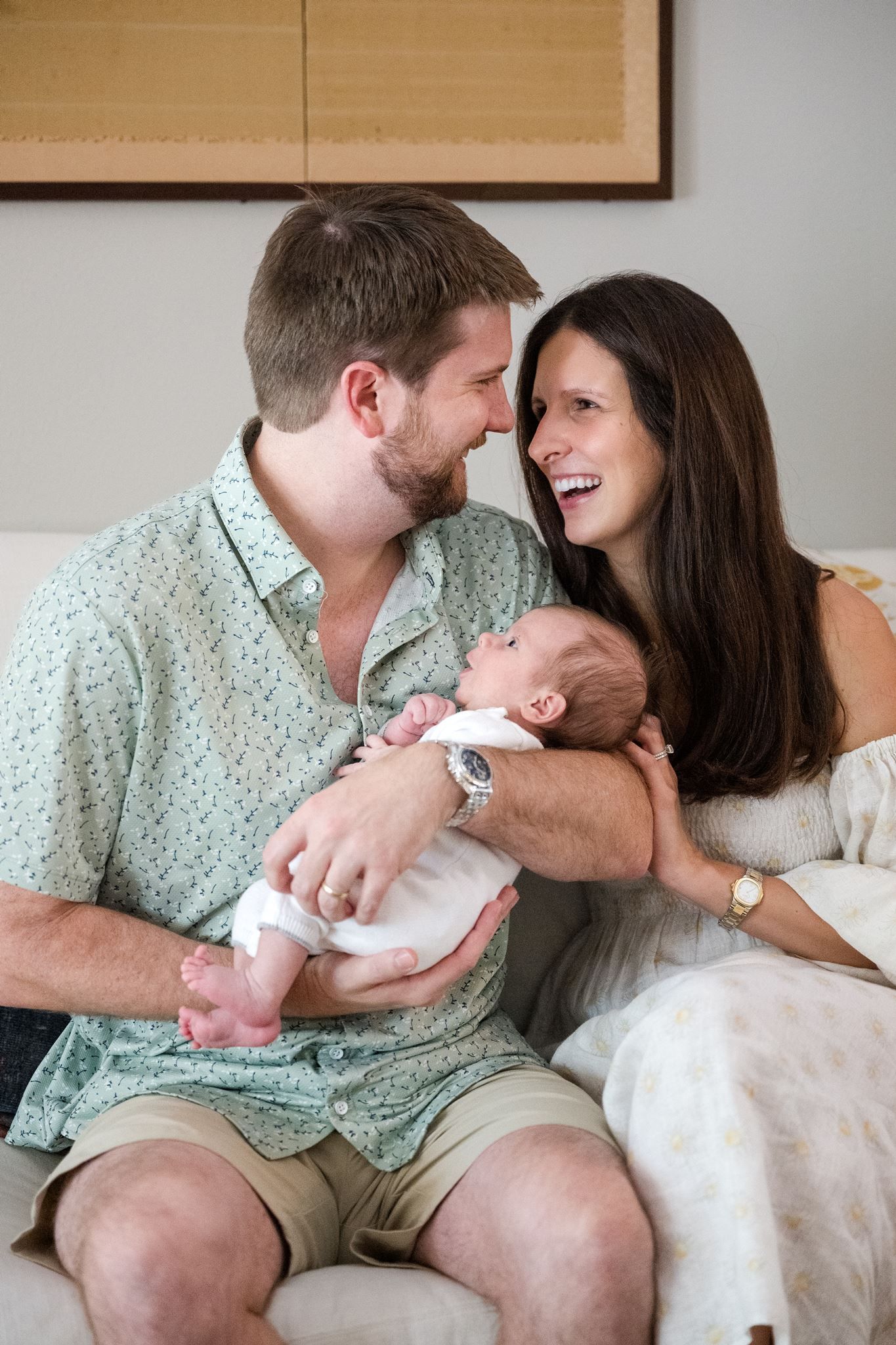 New parents holding their baby during newborn pictures at home in The Woodlands