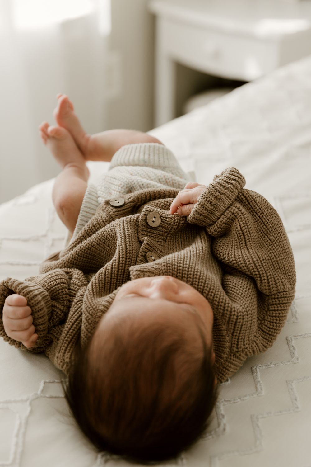 Lifestyle Newborn image on parents bed using natural window light Tyler Tx Newborn Photographer