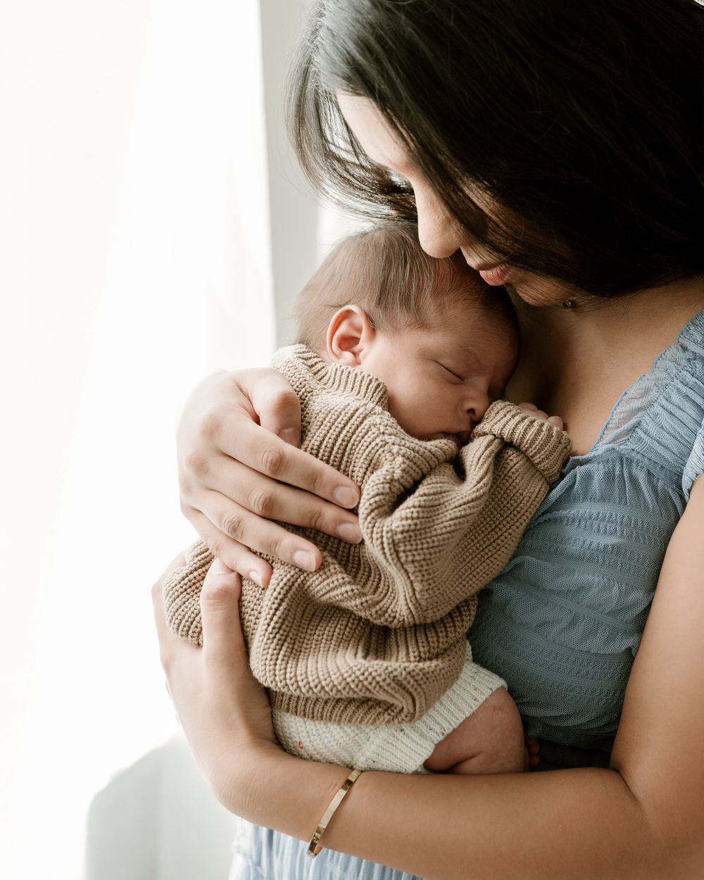 Mother and child window light portrait during in-home newborn portrait session Tyler Texas Motherhood photography