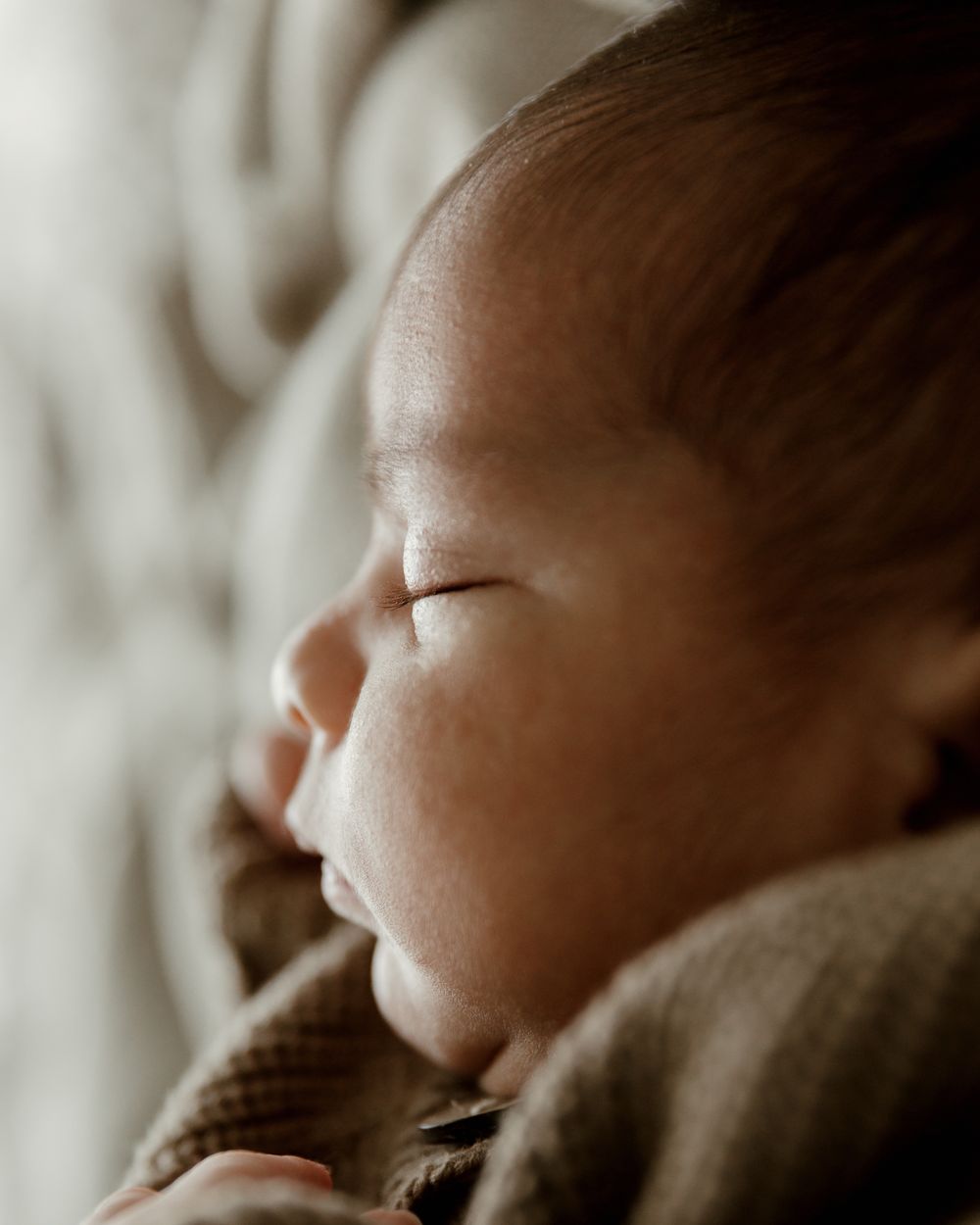 Profile shot of newborn during in-home lifestyle session with Tyler Tx Newborn photographer Motherhood photography