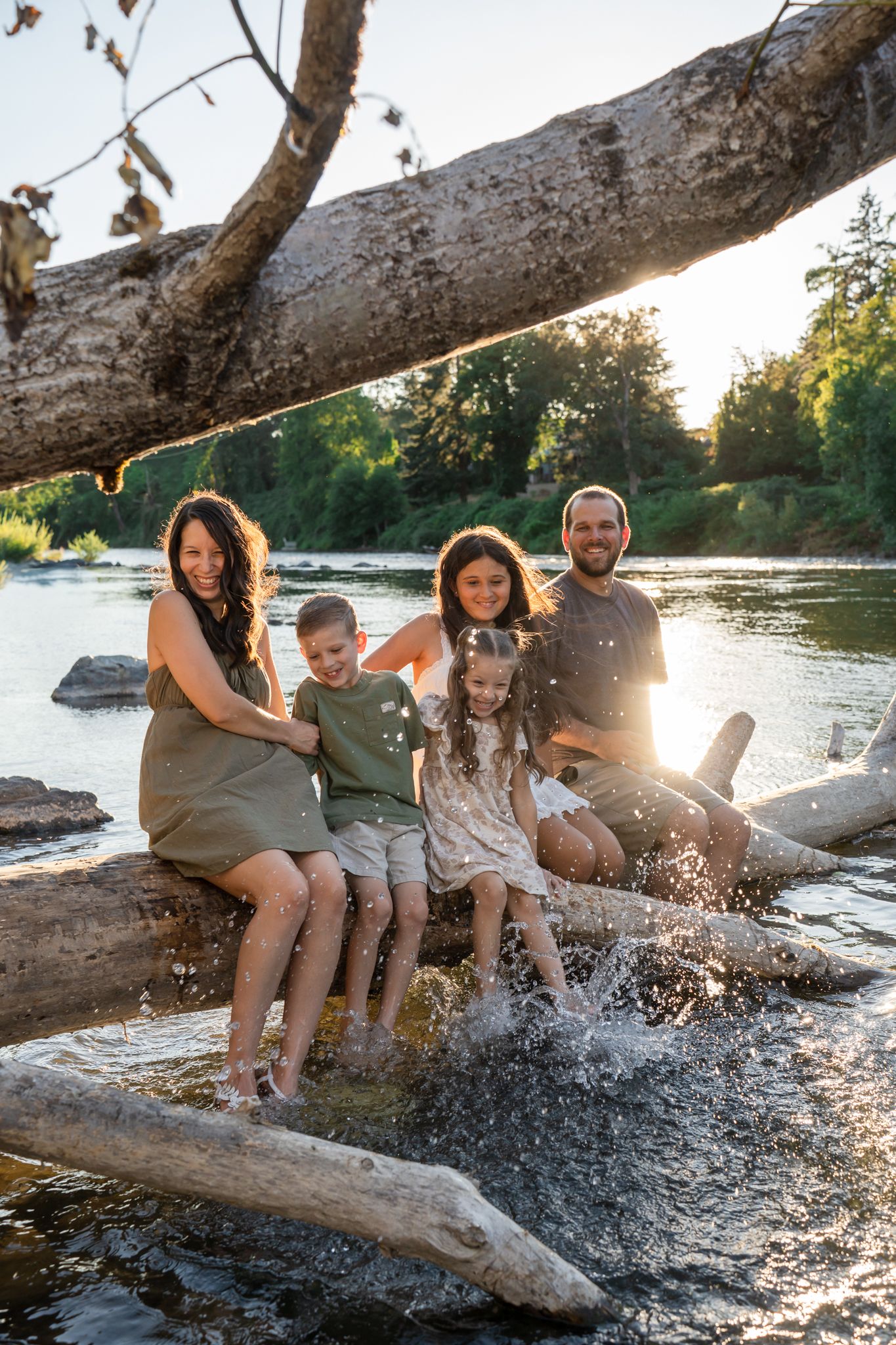 family of 5 splashes in the river for some candid portraits